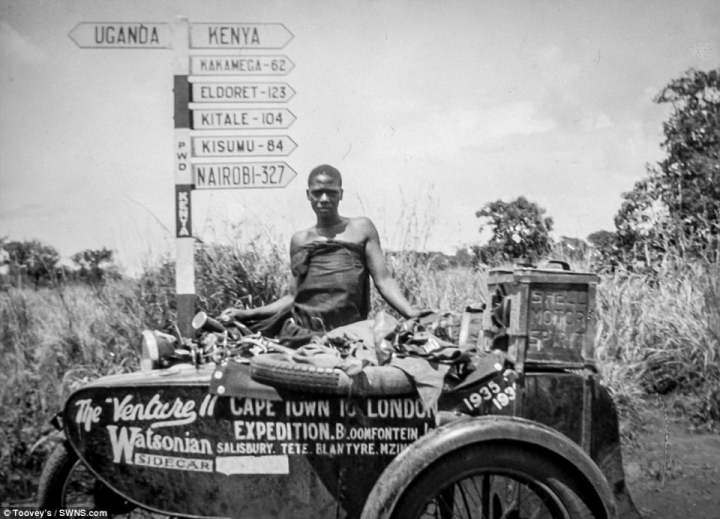 Theresa kept a diary during her travels and later recounted the journey in her book, The Rugged Road, which was illustrated sparsely by stills captured from video footage.& However, no actual pictures existed at the time - but it has now emerged that Florence Blenkiron kept her own photographic diary. Pictured: One of the recently discovered pictures showing the motorbike and a sign post for Uganda and Kenya&