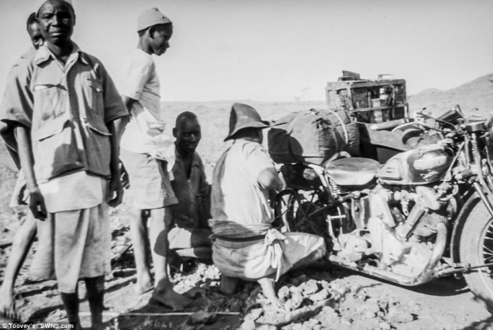 Toovey added: 'They were lovely slides on their own, but obviously then we realised their importance of documenting this crossing across Africa.' Pictured: The bike being worked on among harsh terrain in Africa.& The slides will be auctioned off at Toovey's Auction House on the afternoon of January 23