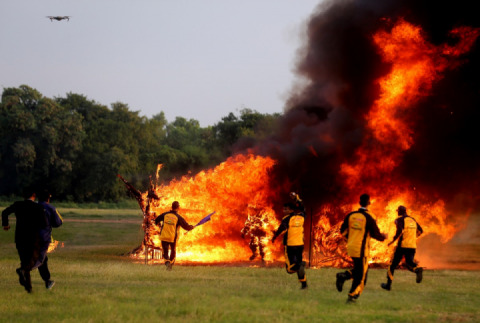 Stuntman on a motorcycle almost burned in a fire tunnel